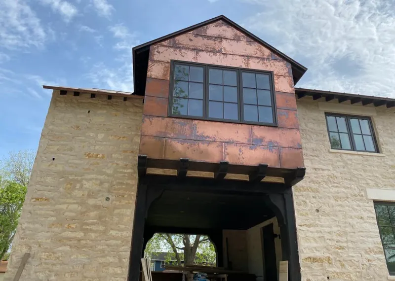 Copper metal panel facade on a stone building for Skylight Installation in Eucalyptus Hills